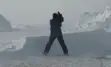 Cameraman standing in the snow.