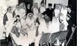 a group of nuns sitting around a table.