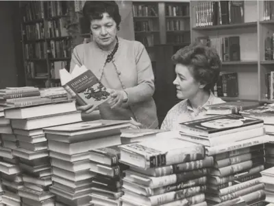 Two women looking at books.