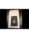 A vintage photograph of a young girl with a large bow in her hair is displayed on an envelope labeled 2016.067.015 4B Clinkman.