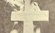 Black and white image of a soldier statue standing behind a cross, part of the Petrolia and Enniskillen Soldiers’ Memorial.