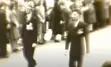 Sepia photo of two men walking. 